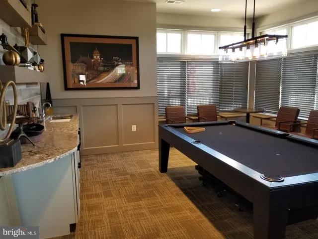 a view of a patio with dining table and chairs with the view of the small garden
