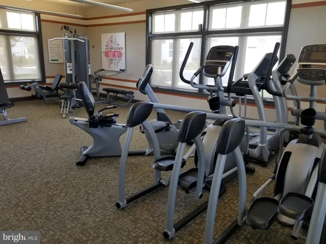 a view of swimming pool with seating area and barbeque oven