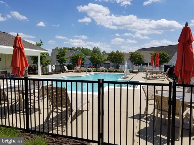 a view of a patio with dining table and chairs potted plants
