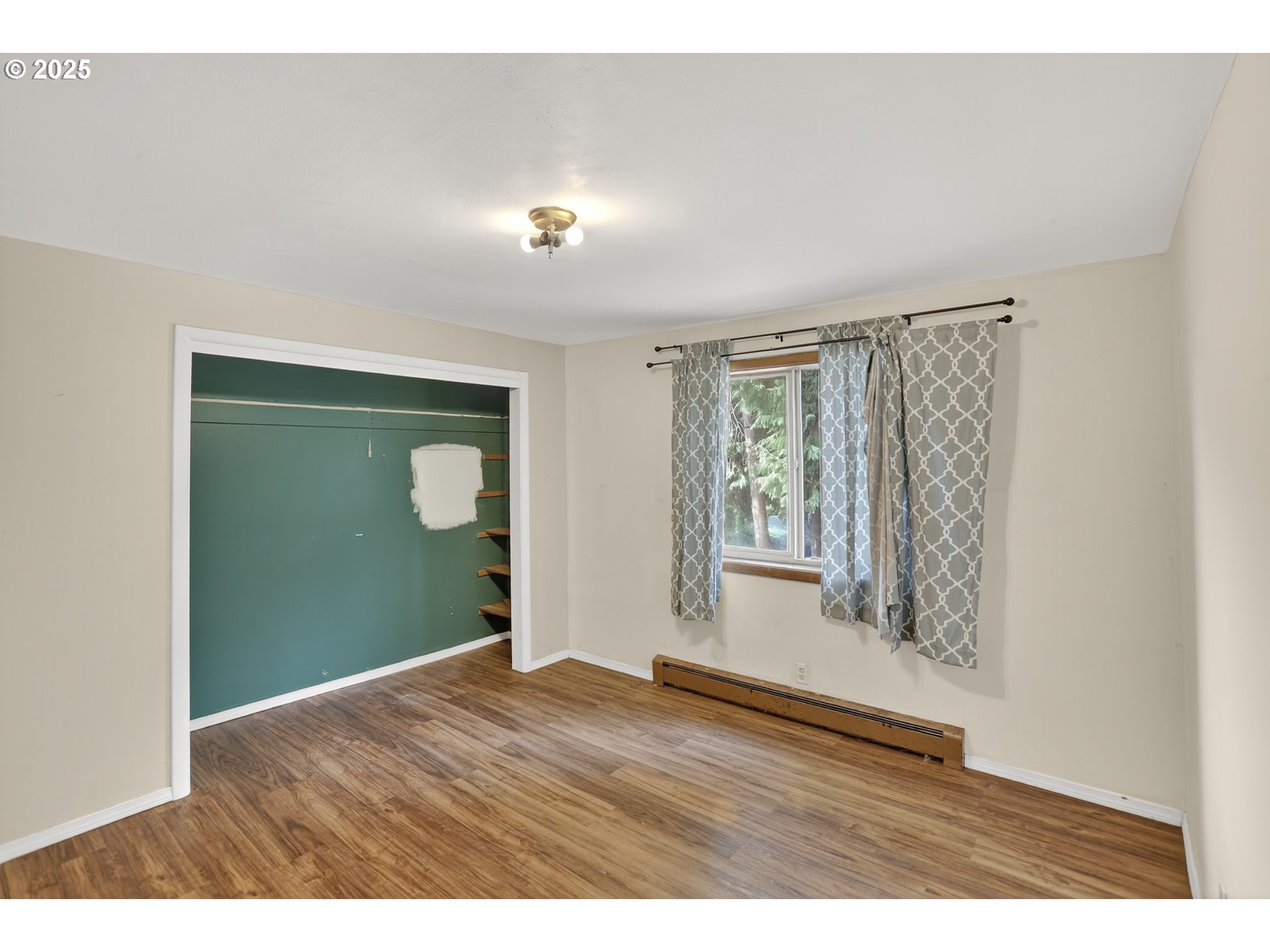 31444 New Kirk Road Scappoose, OR 97056 - Photo 17 of 43 a view of an empty room with wooden floor and a window