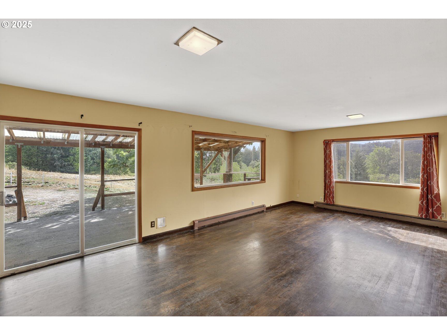 31444 New Kirk Road Scappoose, OR 97056 - Photo 8 of 43 an empty room with wooden floor and windows