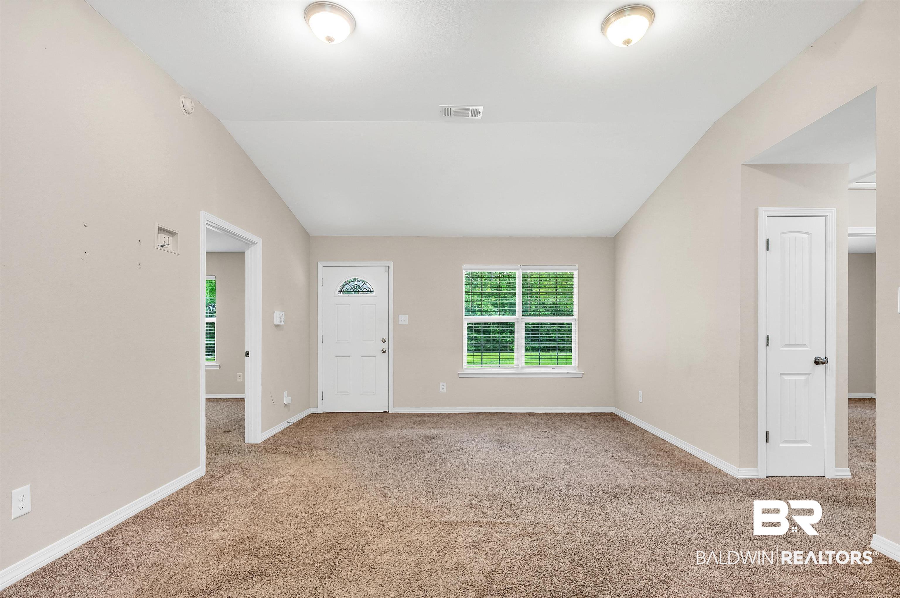 22810 Ard Road Robertsdale, AL 36567 - Photo 25 of 65 Living Area featuring vaulted ceiling and carpet floors