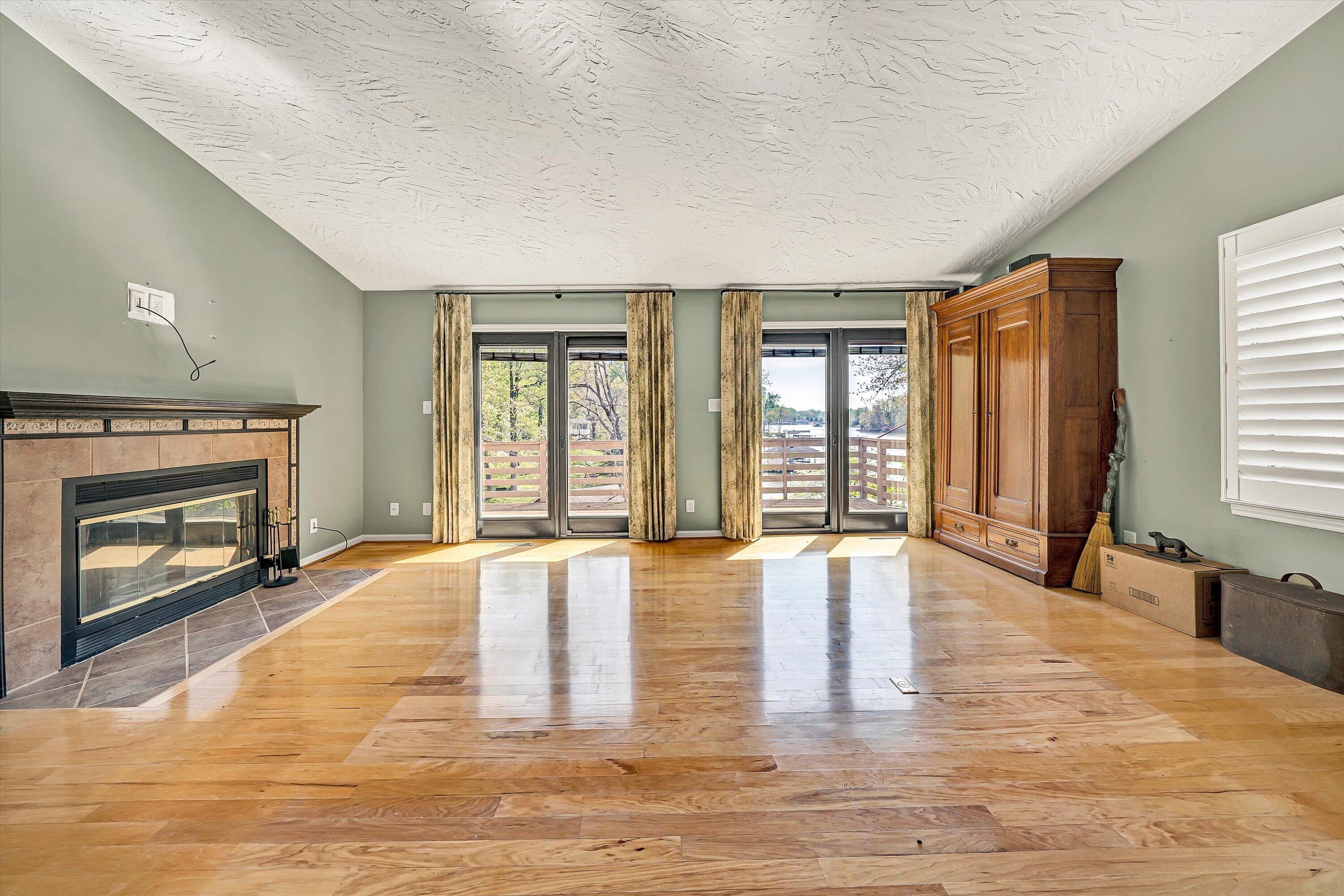 259 Brooks Point Lane Union Hall, VA 24176 - Photo 13 of 59 wooden floor fireplace and windows in an empty room