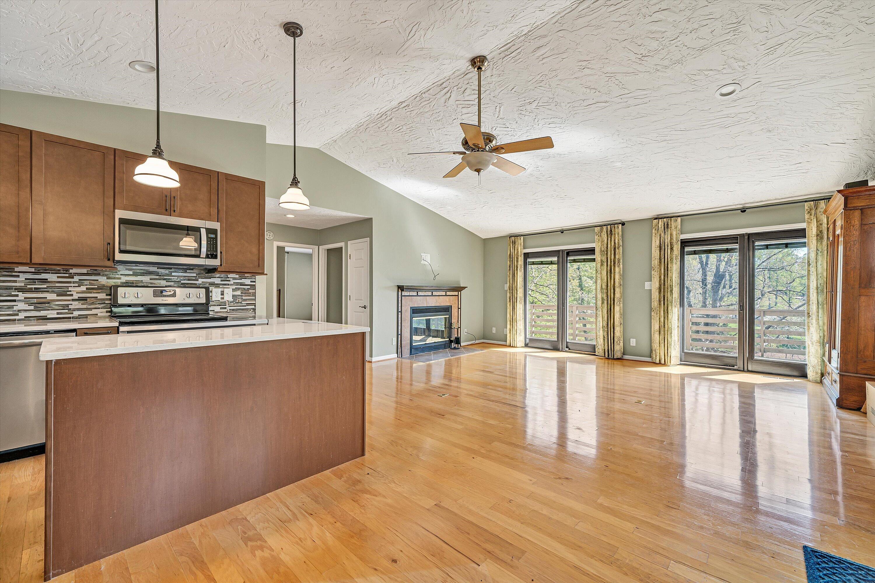 259 Brooks Point Lane Union Hall, VA 24176 - Photo 14 of 59 a open kitchen with stainless steel appliances granite countertop a stove a sink a center island with wooden floor and cabinets