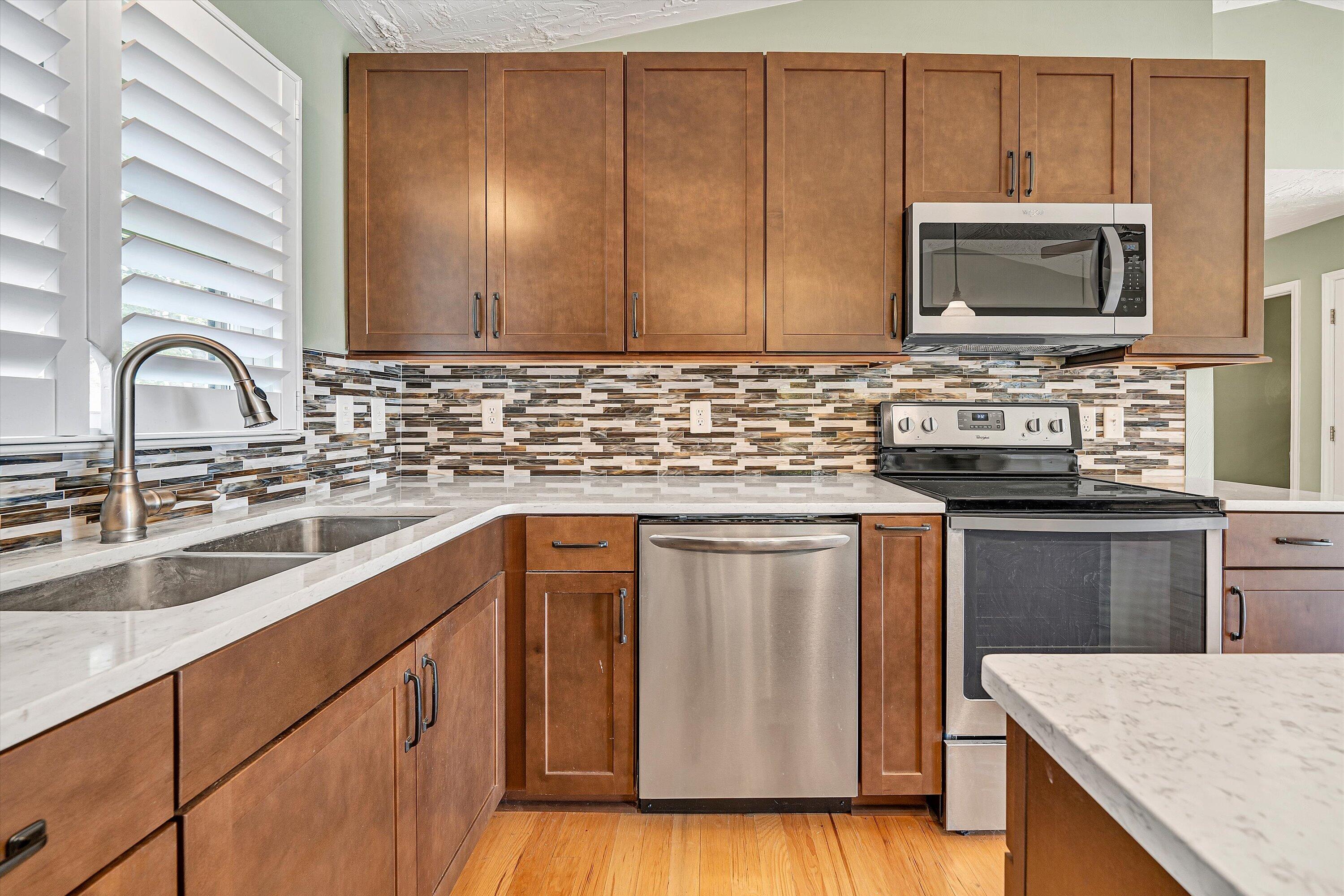 259 Brooks Point Lane Union Hall, VA 24176 - Photo 18 of 59 a kitchen with stainless steel appliances granite countertop a sink a stove microwave and cabinets