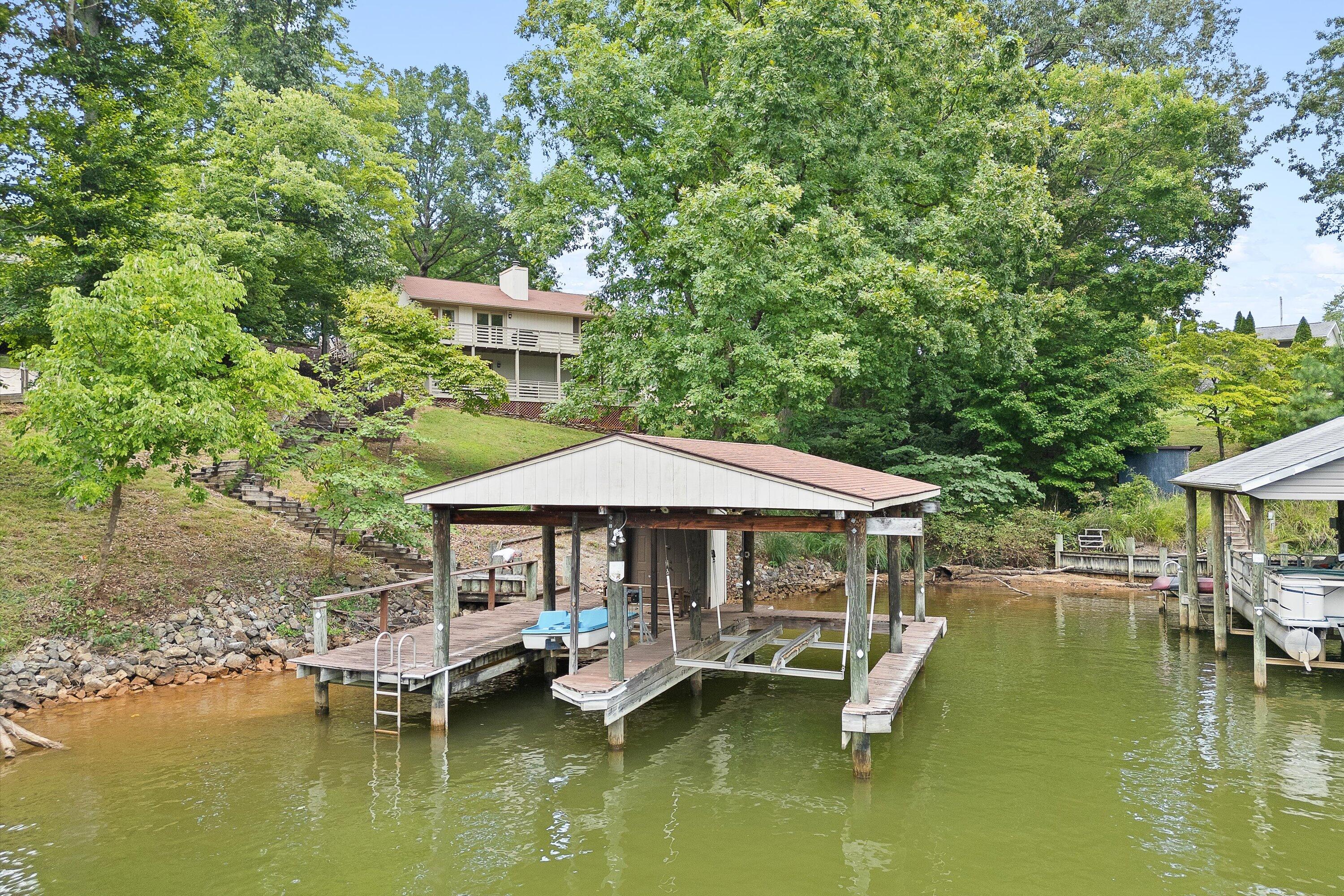 259 Brooks Point Lane Union Hall, VA 24176 - Photo 40 of 59 a backyard with a table and chairs under an umbrella