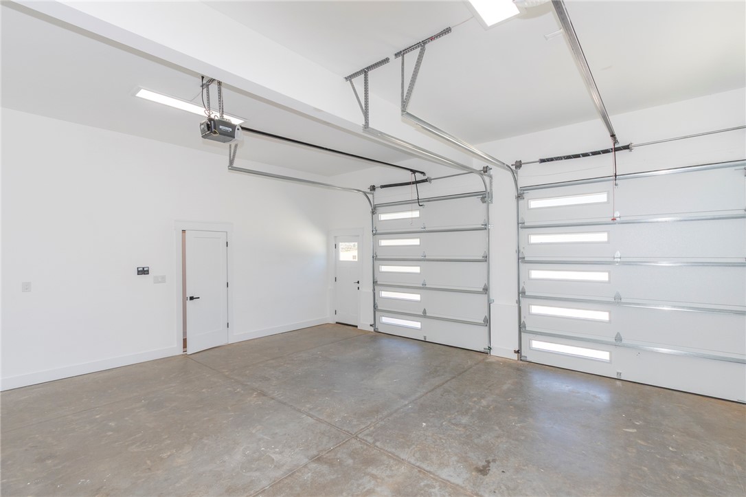 230 Hammond Circle Anderson, SC 29621 - Photo 41 of 48 This spacious, well-lit garage features multiple doors and durable concrete flooring.