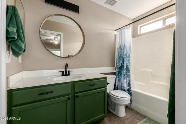 a bathroom with a toilet a sink and a mirror