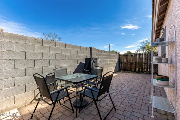 a view of a backyard with furniture and a terrace