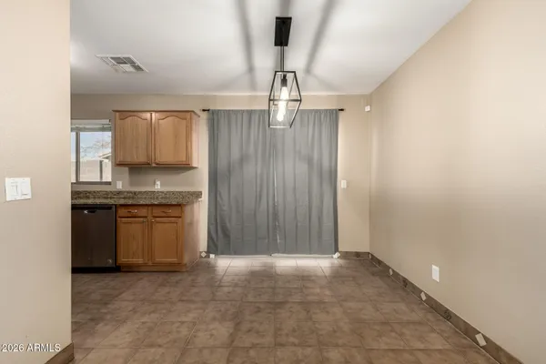 a view of kitchen with granite countertop a stove top oven a sink and dishwasher