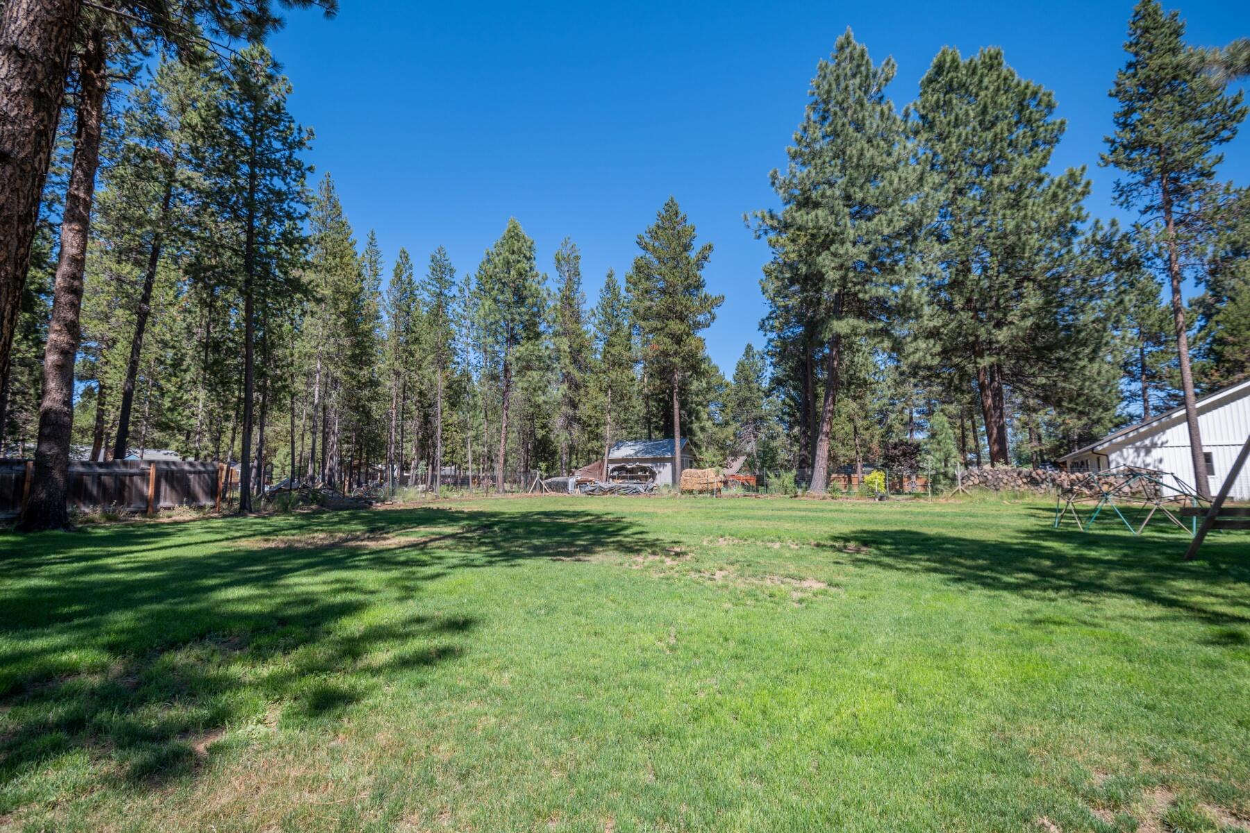 16990 Covina Road Bend, OR 97707 - Photo 43 of 56 a view of a grassy field with trees