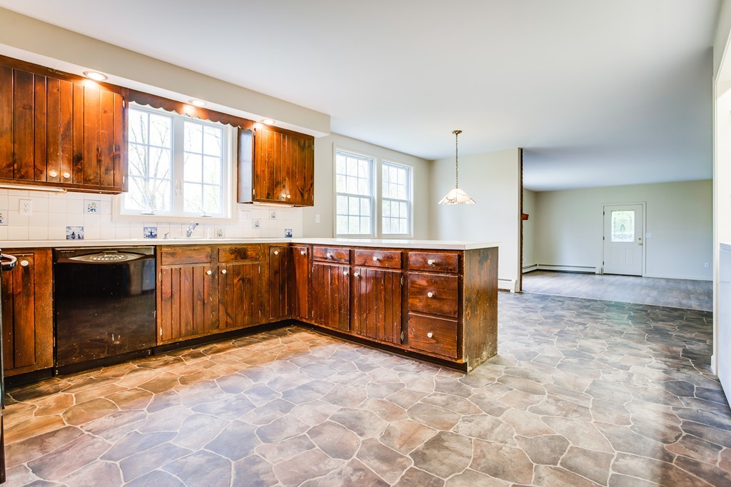 233 Middle Road Newbury, MA 01922 - Photo 6 of 30 a kitchen with stainless steel appliances granite countertop a stove sink and cabinets