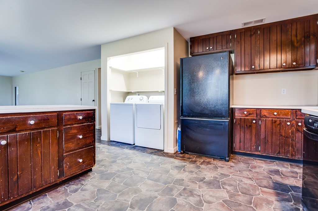 233 Middle Road Newbury, MA 01922 - Photo 9 of 30 a kitchen with a refrigerator and cabinets