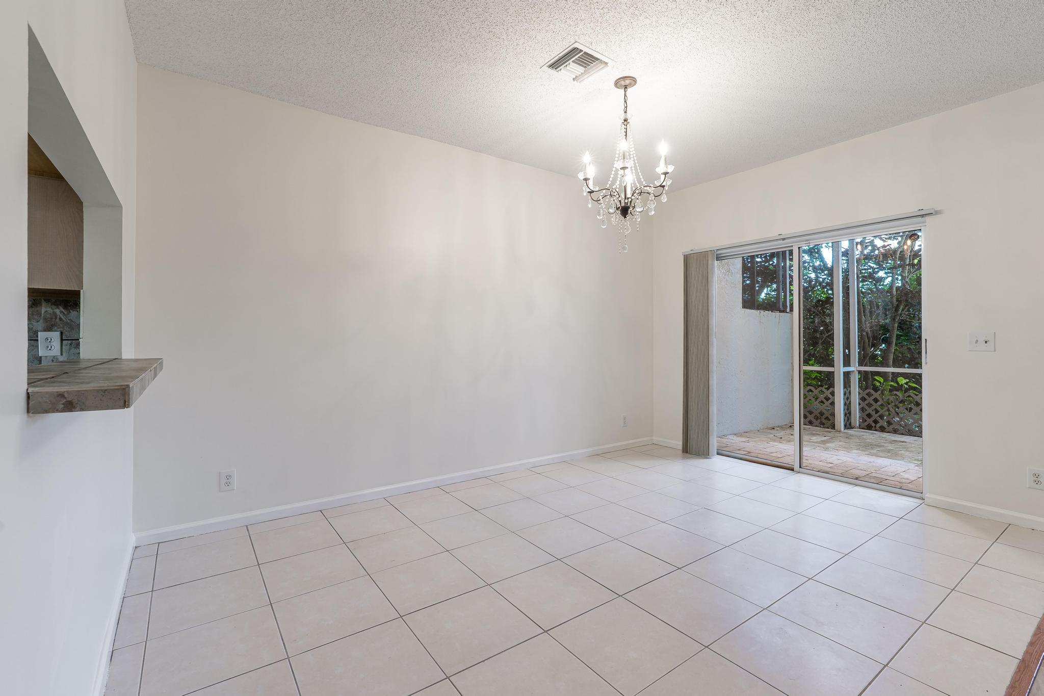 8271 Vía Serena Boca Raton, FL 33433 - Photo 12 of 33 a view of an empty room with glass door