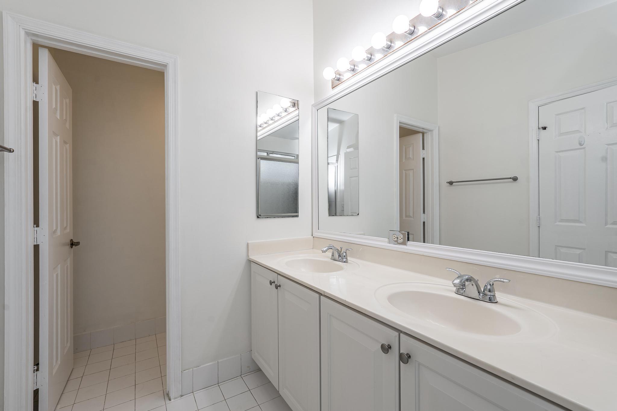 8271 Vía Serena Boca Raton, FL 33433 - Photo 18 of 33 a bathroom with a sink and a mirror