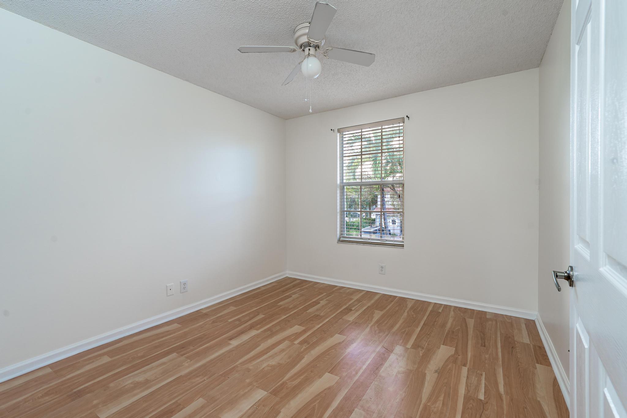 8271 Vía Serena Boca Raton, FL 33433 - Photo 21 of 33 wooden floor in an empty room with a window