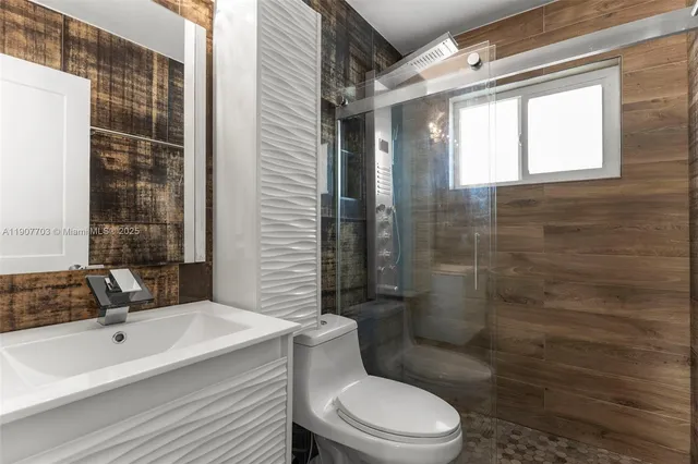 a bathroom with a sink toilet and shower