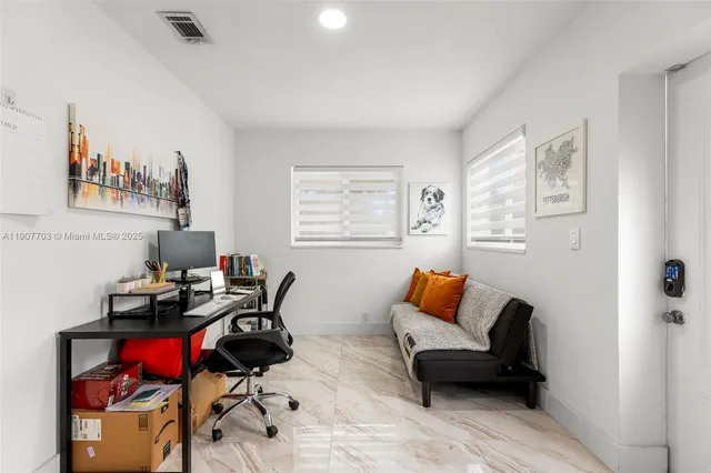 a living room with furniture a rug and a window