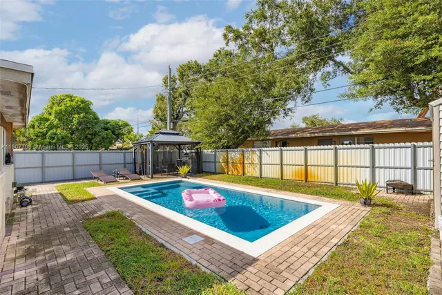 a view of a backyard with swimming pool