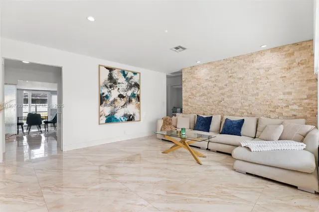 a living room with furniture and painting on the wall