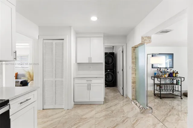 a view of kitchen with refrigerator and window