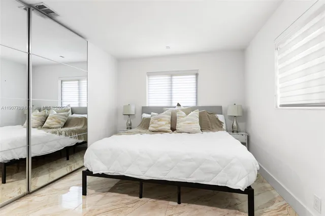 a bedroom with a bed and a couch