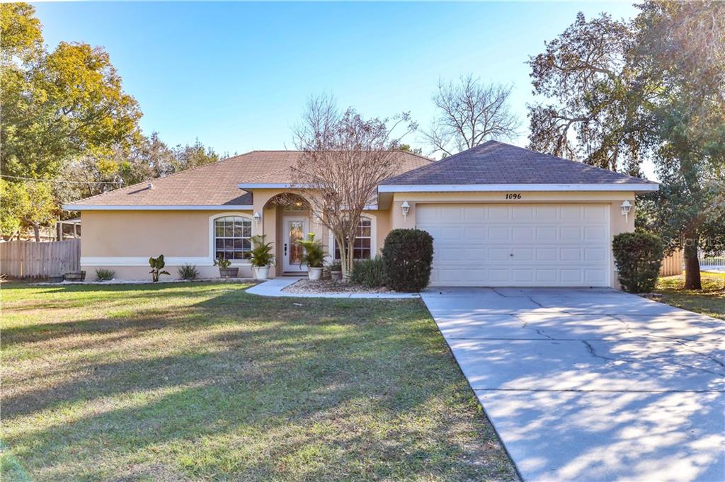 1096 Hallcrest Avenue Spring Hill, FL 34608 - Photo 1 of 1 a front view of a house with a garden
