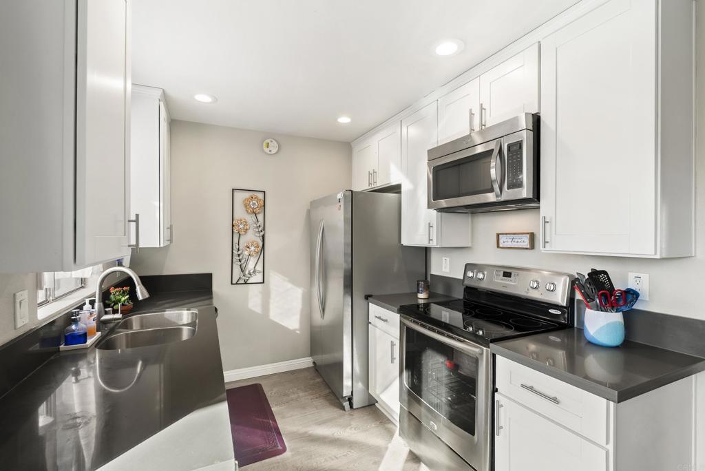 a kitchen with a sink stove and refrigerator
