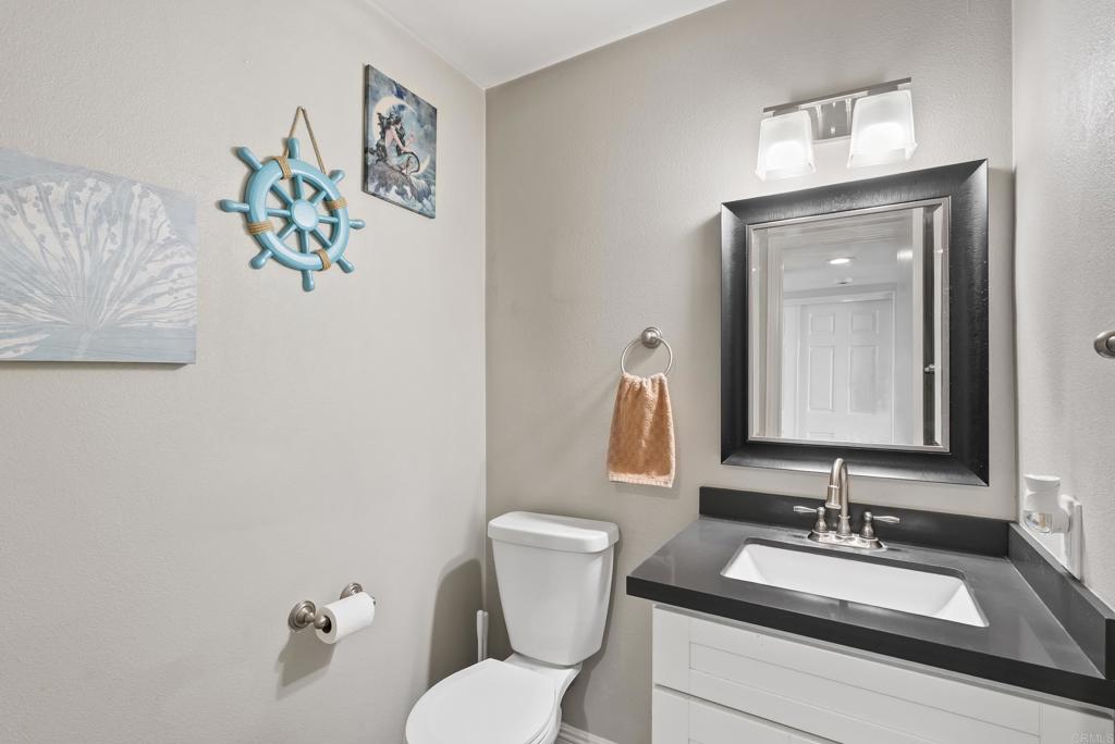 12553 Mapleview Street, Unit 8 Lakeside, CA 92040 - Photo 12 of 23 a bathroom with a granite countertop sink mirror and toilet
