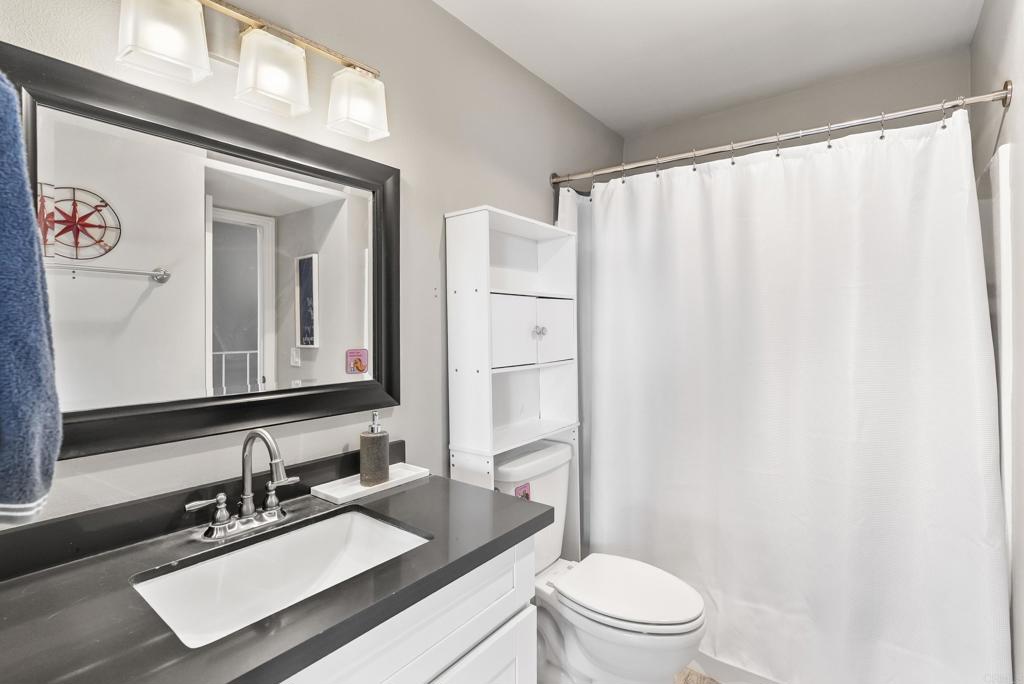 12553 Mapleview Street, Unit 8 Lakeside, CA 92040 - Photo 15 of 23 a bathroom with a sink a toilet and a mirror