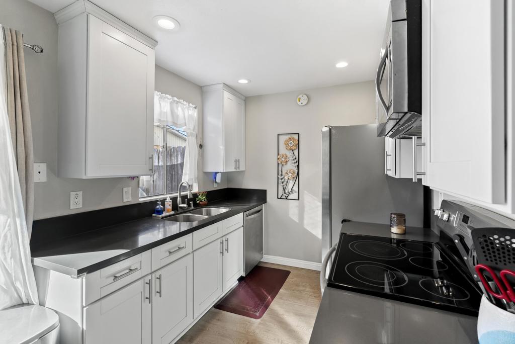 12553 Mapleview Street, Unit 8 Lakeside, CA 92040 - Photo 3 of 23 a kitchen with granite countertop a sink stainless steel appliances and cabinets