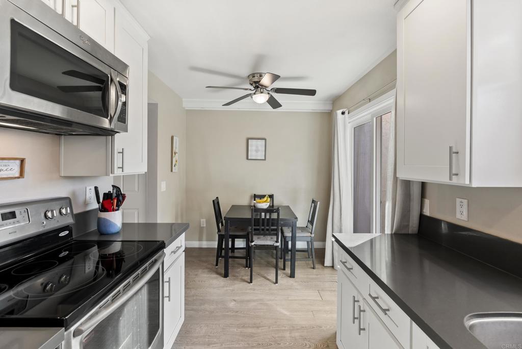 12553 Mapleview Street, Unit 8 Lakeside, CA 92040 - Photo 5 of 23 a kitchen with stainless steel appliances granite countertop a sink stove and microwave