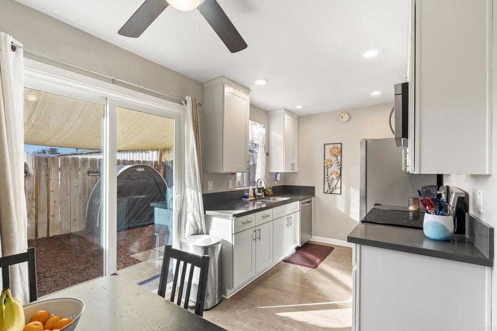 12553 Mapleview Street, Unit 8 Lakeside, CA 92040 - Photo 6 of 23 a kitchen with stainless steel appliances granite countertop a sink refrigerator and cabinets