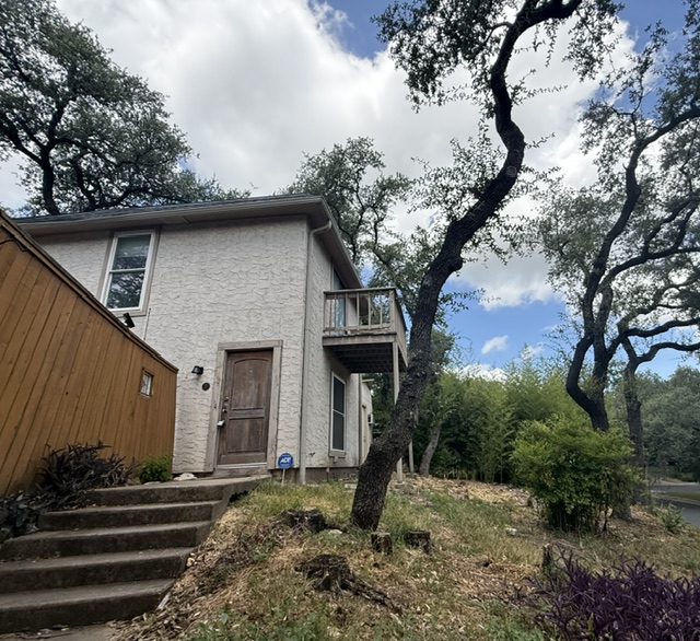 3304 Clawson Road, Unit B Austin, TX 78704 - Photo 1 of 12 A charming stucco exterior features a private balcony and mature trees for shaded curb appeal.