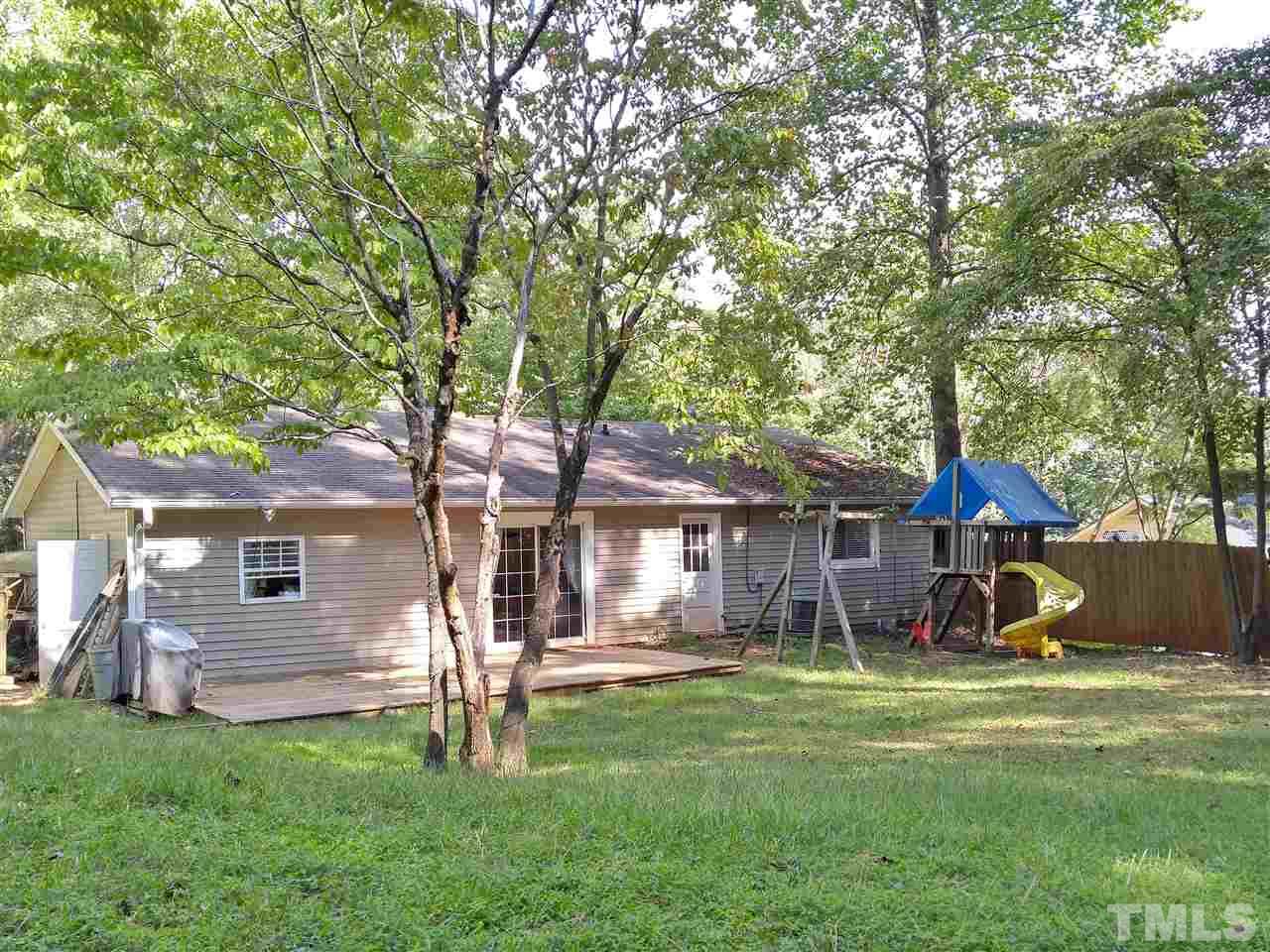 7524 Stuart Drive Raleigh, NC 27615 - Photo 14 of 18 a view of a house with a yard porch and sitting area