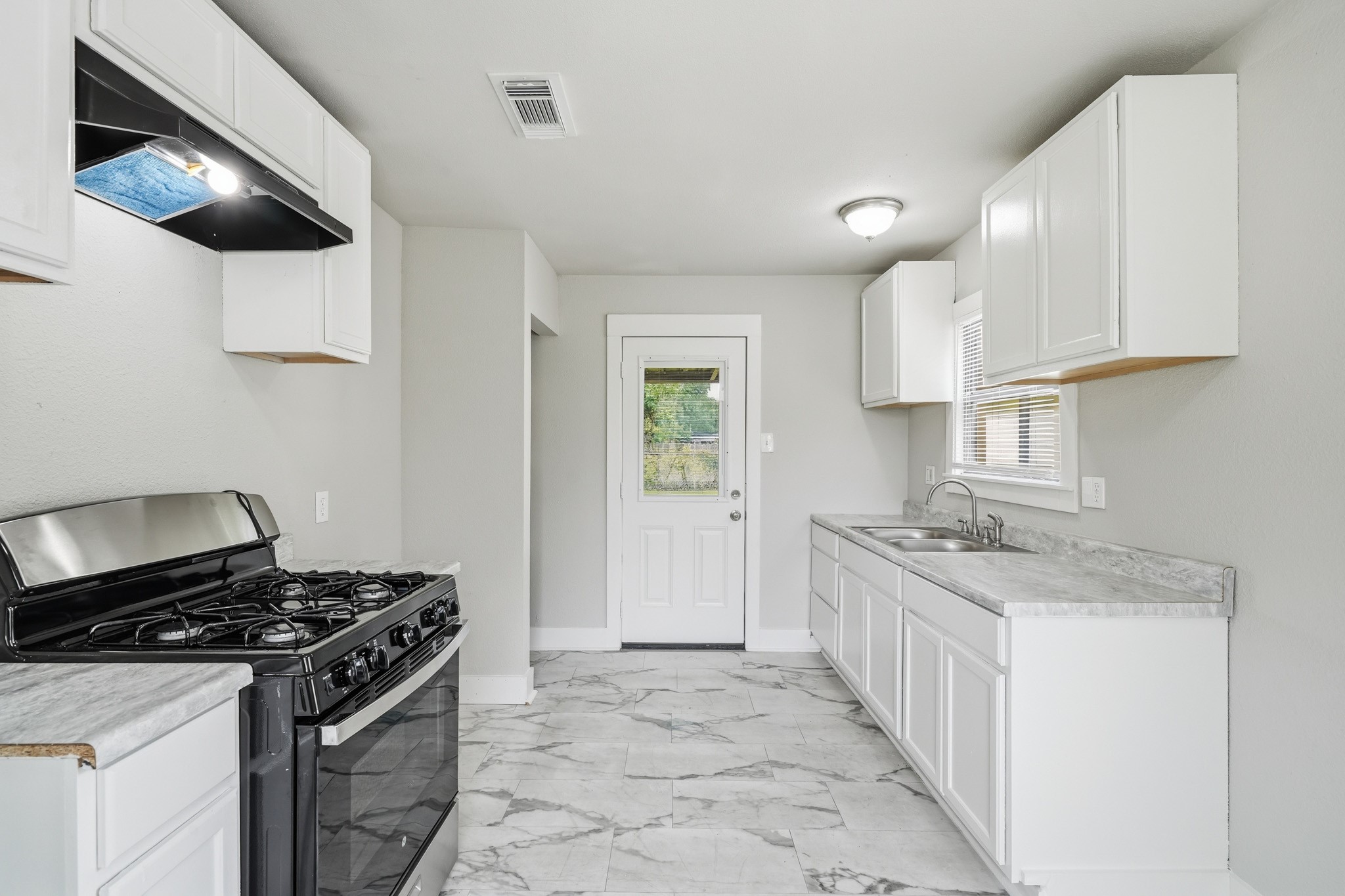 1718 Miami Road Pasadena, TX 77502 - Photo 5 of 11 a kitchen with stainless steel appliances granite countertop a stove and a sink