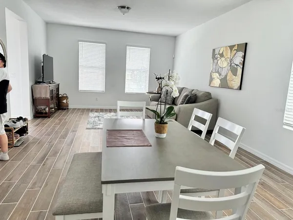 a view of a dining room with furniture and a window