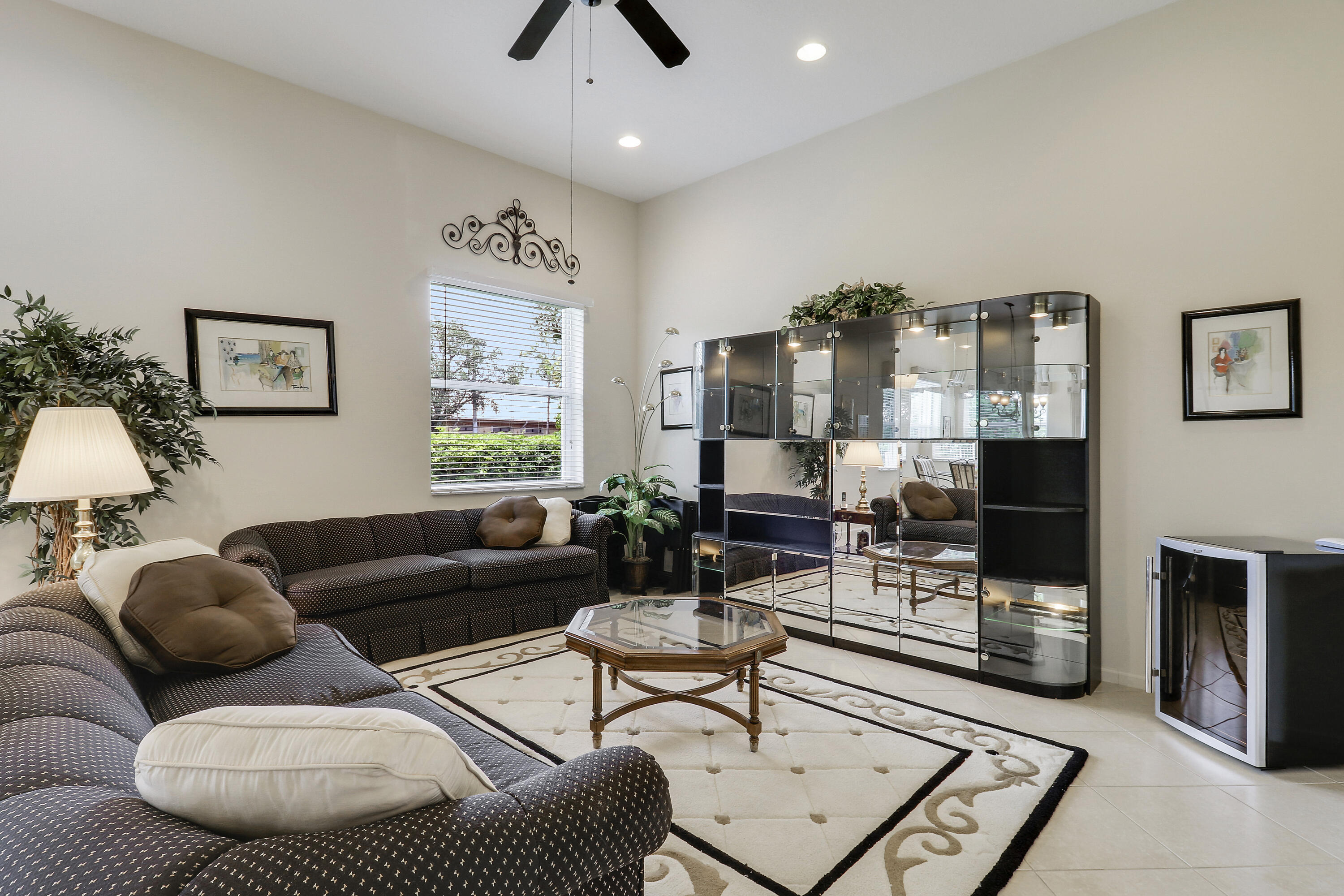 6565 Garde Road Boynton Beach, FL 33472 - Photo 16 of 54 a living room with furniture and a flat screen tv
