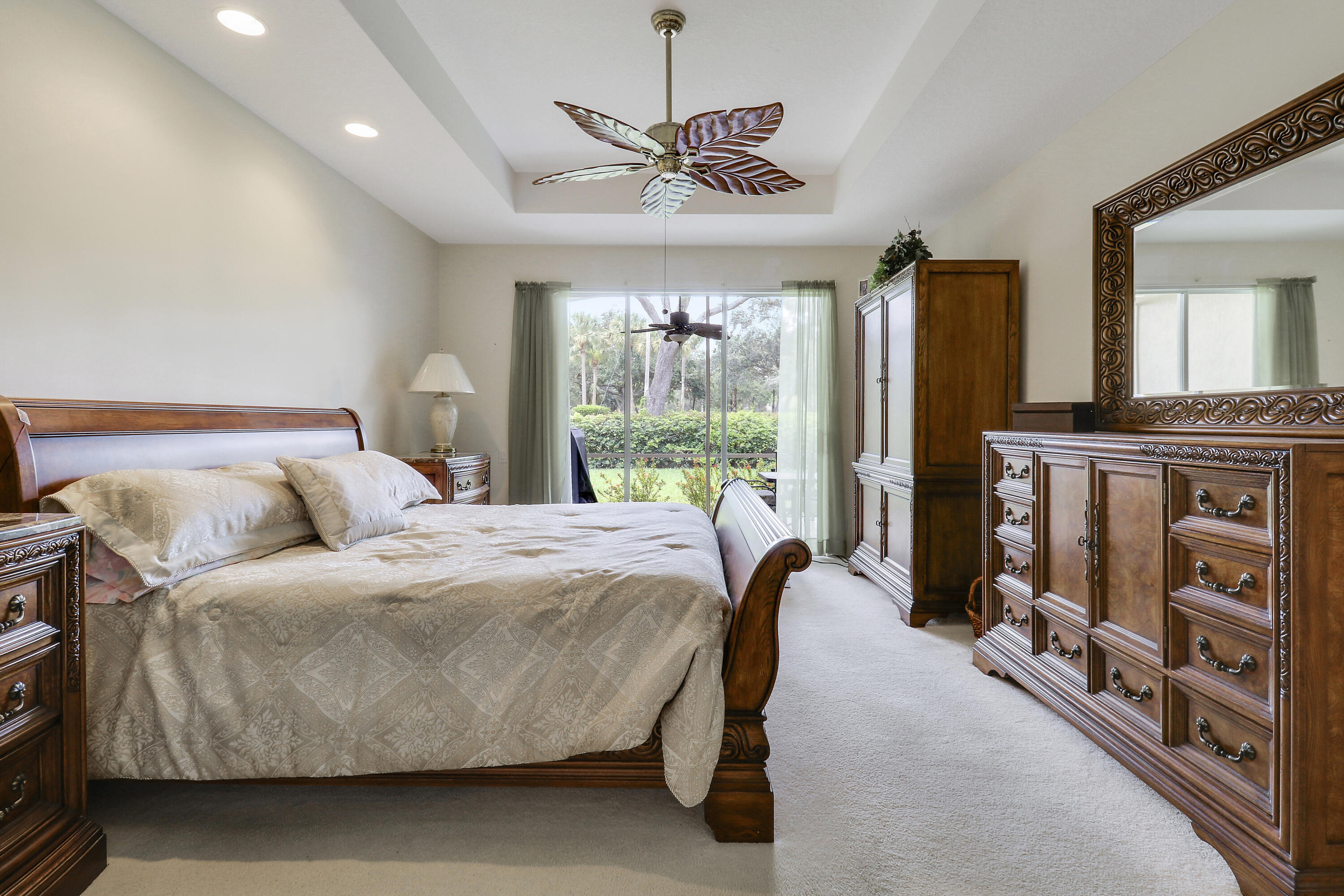6565 Garde Road Boynton Beach, FL 33472 - Photo 28 of 54 a bed room with a bed and a chandelier