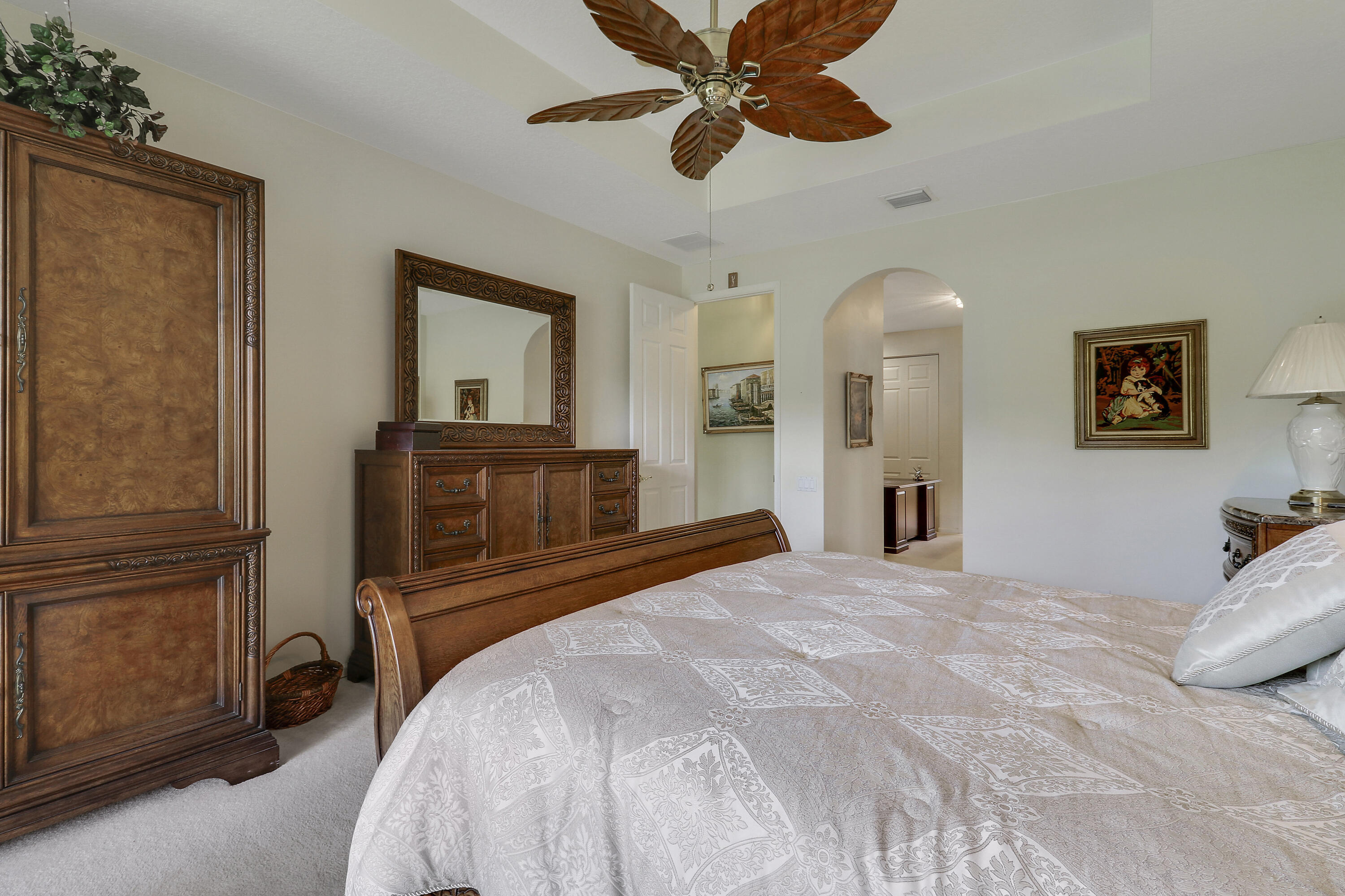 6565 Garde Road Boynton Beach, FL 33472 - Photo 29 of 54 a bedroom with a bed and a chandelier