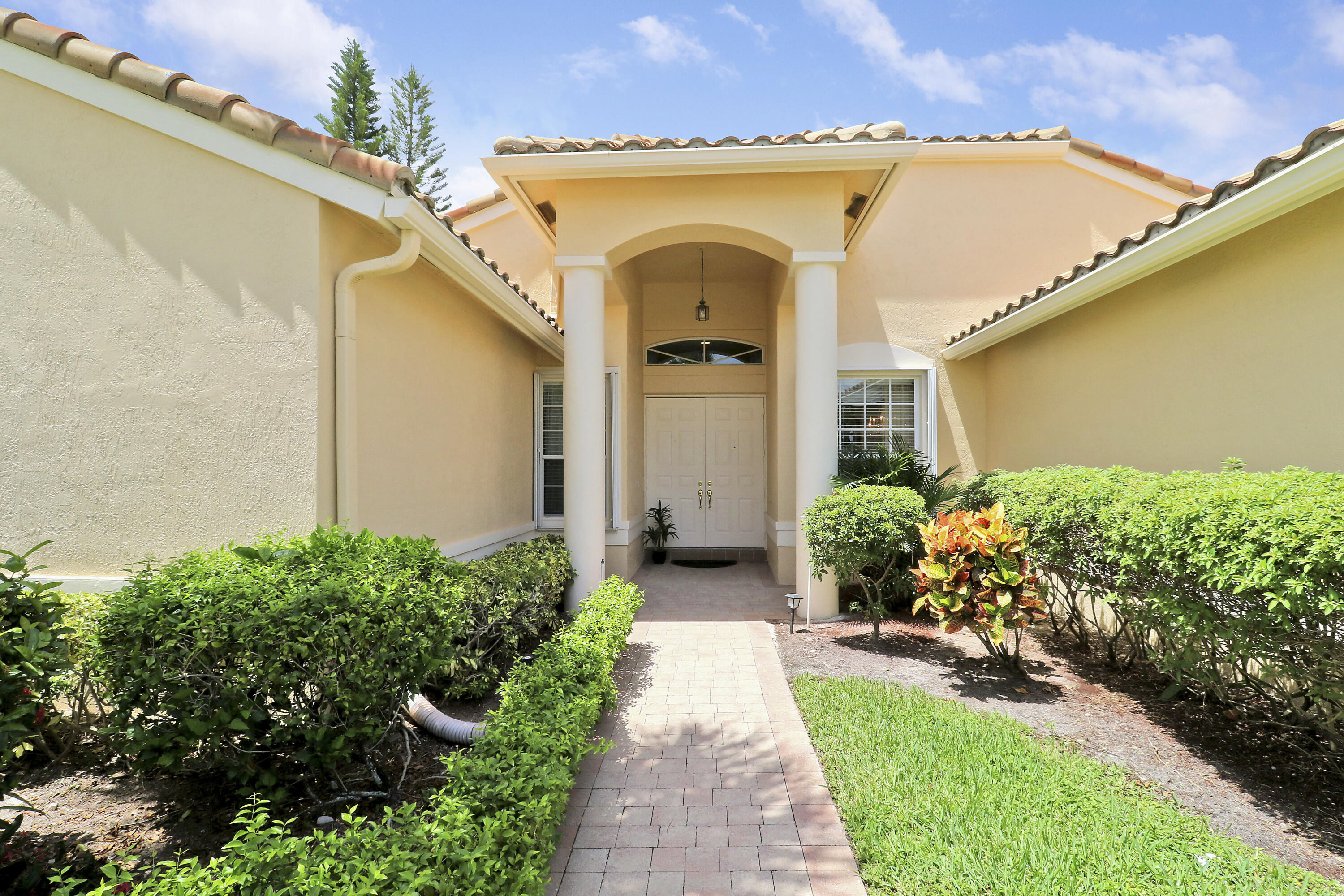 6565 Garde Road Boynton Beach, FL 33472 - Photo 3 of 54 a front view of a house with garden