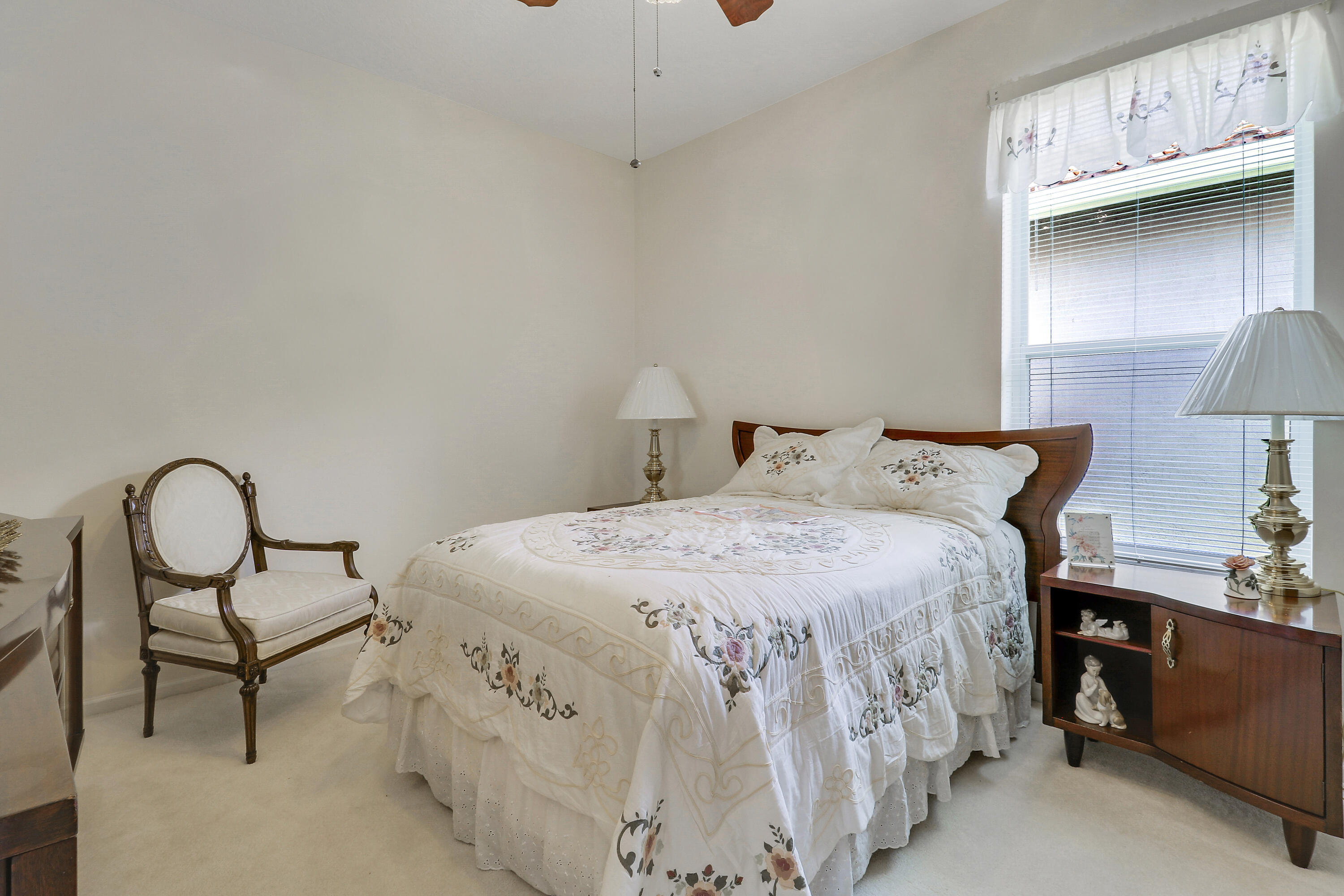 6565 Garde Road Boynton Beach, FL 33472 - Photo 37 of 54 a bedroom with a bed and a table