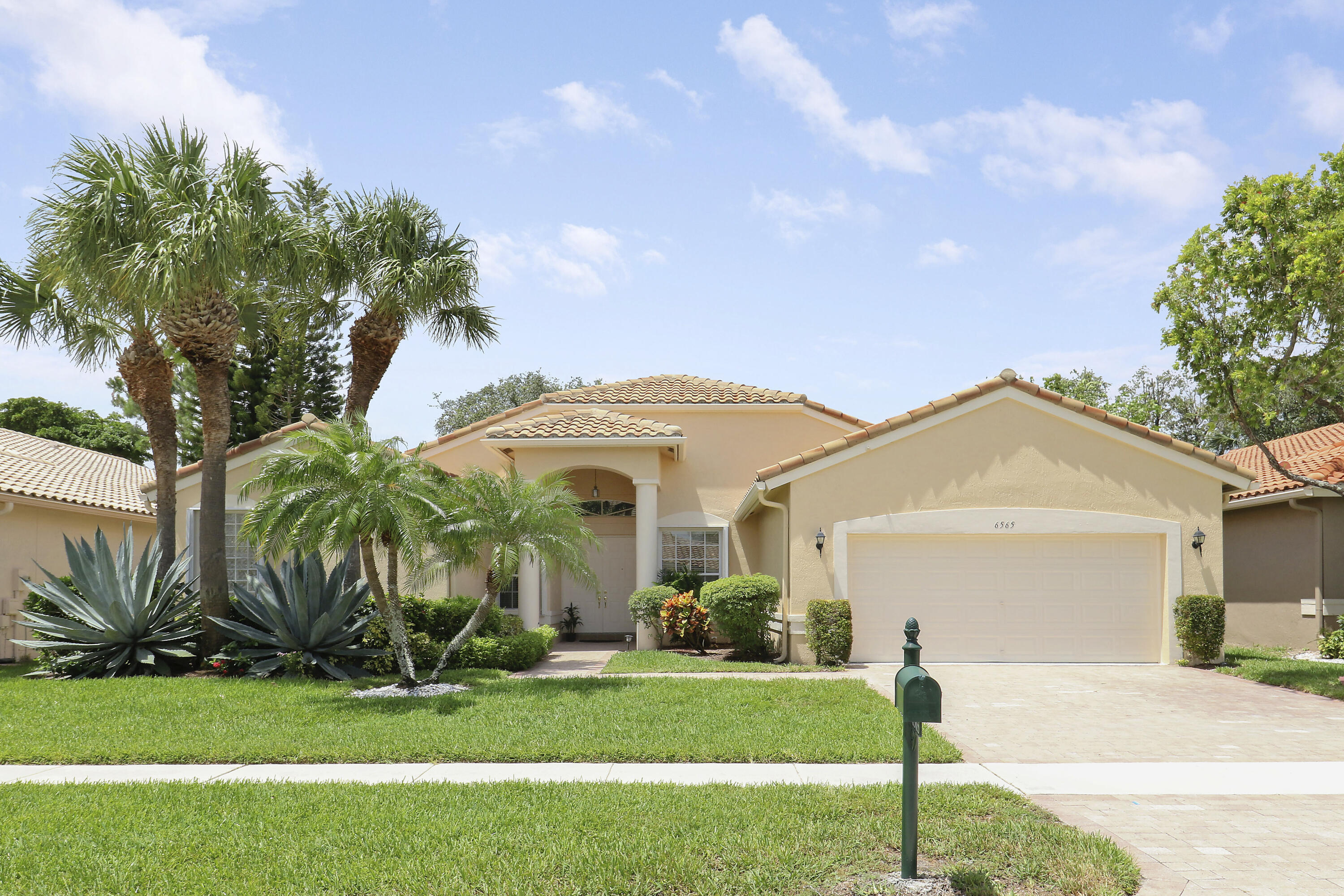 6565 Garde Road Boynton Beach, FL 33472 - Photo 39 of 54 a front view of a house with a yard