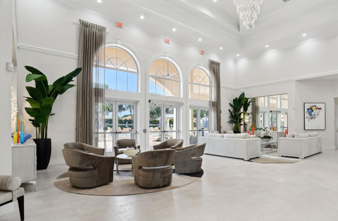6565 Garde Road Boynton Beach, FL 33472 - Photo 47 of 54 a living room with furniture a chandelier and a large window