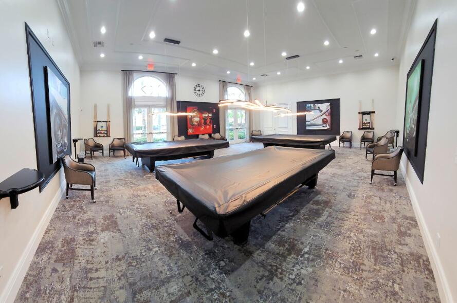 6565 Garde Road Boynton Beach, FL 33472 - Photo 49 of 54 a living room with furniture a flat screen tv and a refrigerator