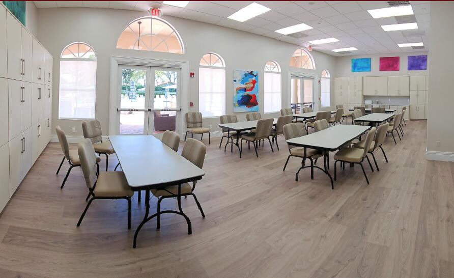6565 Garde Road Boynton Beach, FL 33472 - Photo 50 of 54 a view of a a dining room with furniture window and wooden floor