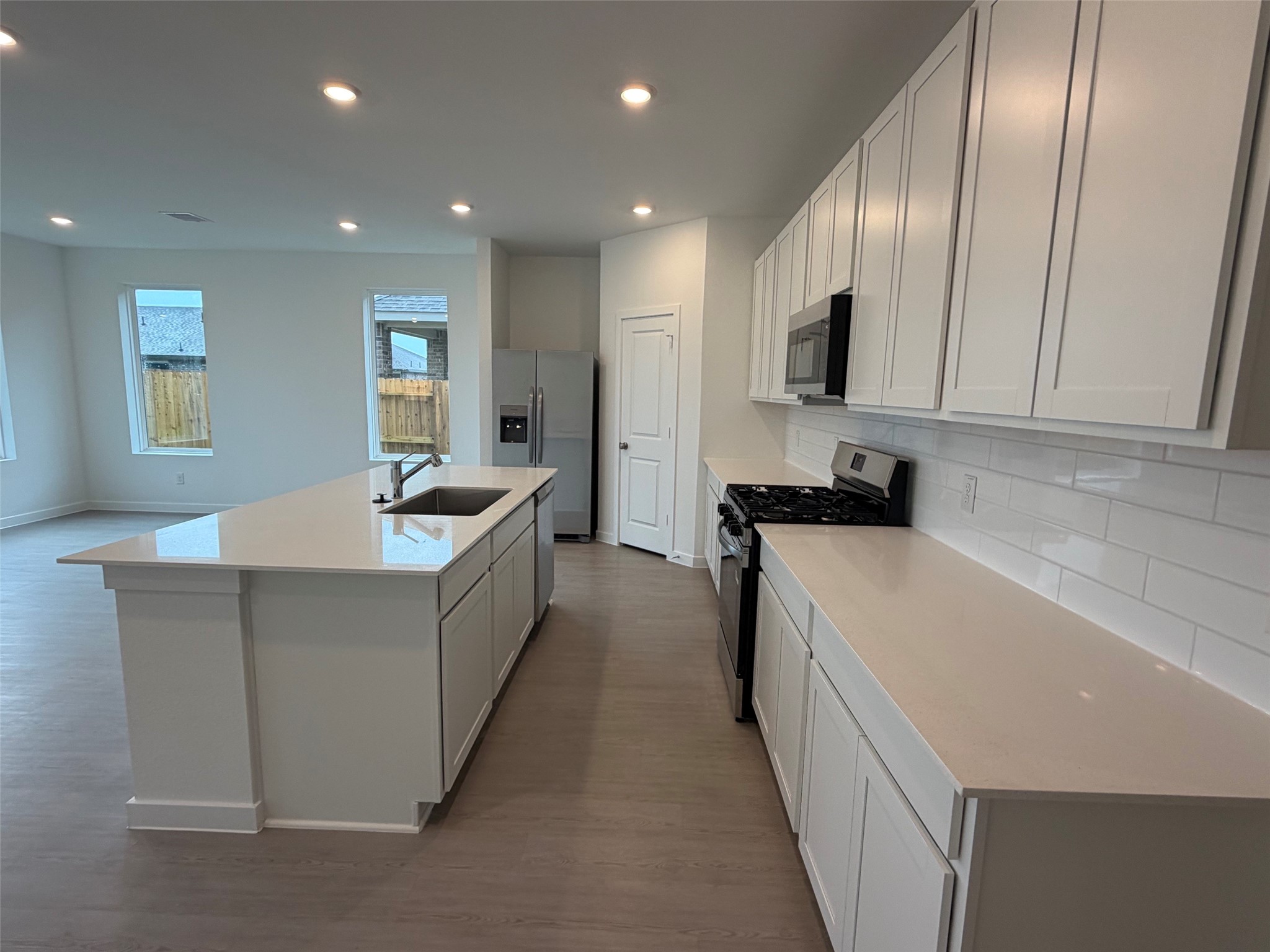 2514 Rose Gold Drive Rosharon, TX 77583 - Photo 7 of 27 a large kitchen with stainless steel appliances lots of counter space and wooden floor
