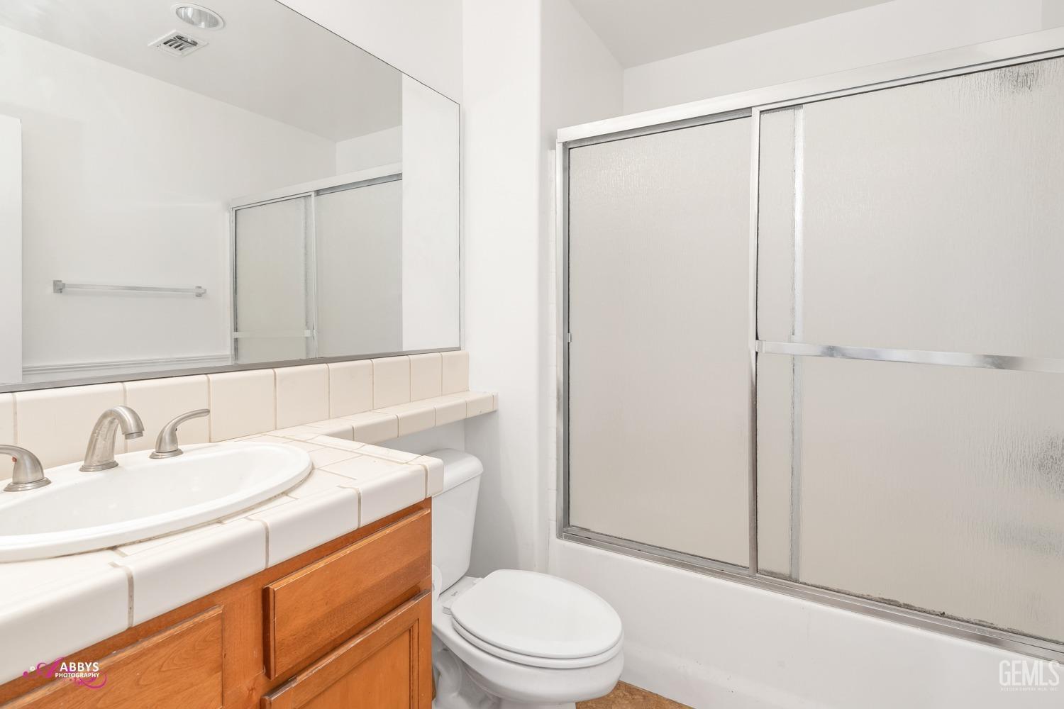 Undisclosed Address Bakersfield, CA 93312 - Photo 16 of 44 a bathroom with a sink a toilet and shower