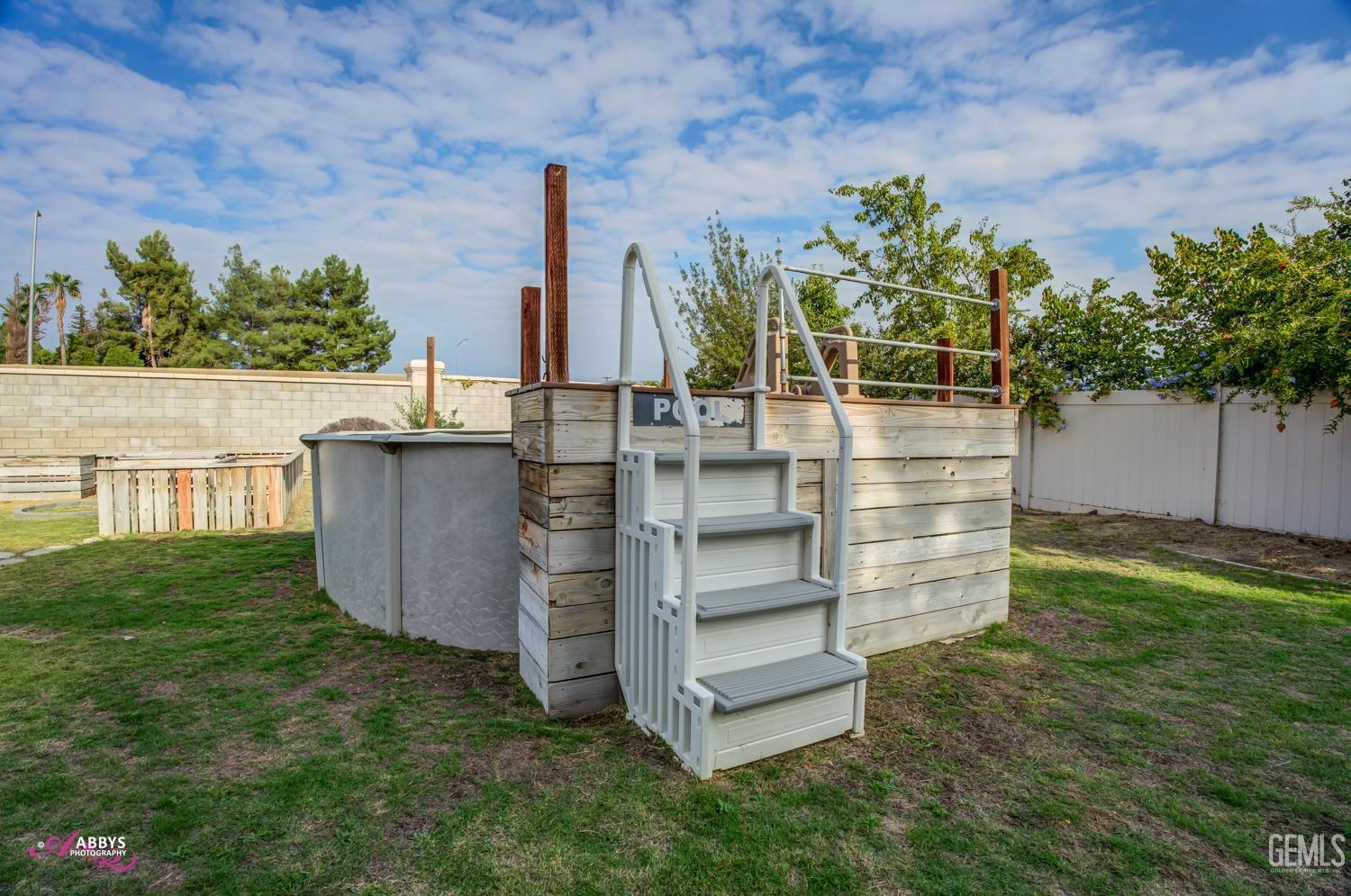 Undisclosed Address Bakersfield, CA 93312 - Photo 2 of 44 a view of a backyard with plants