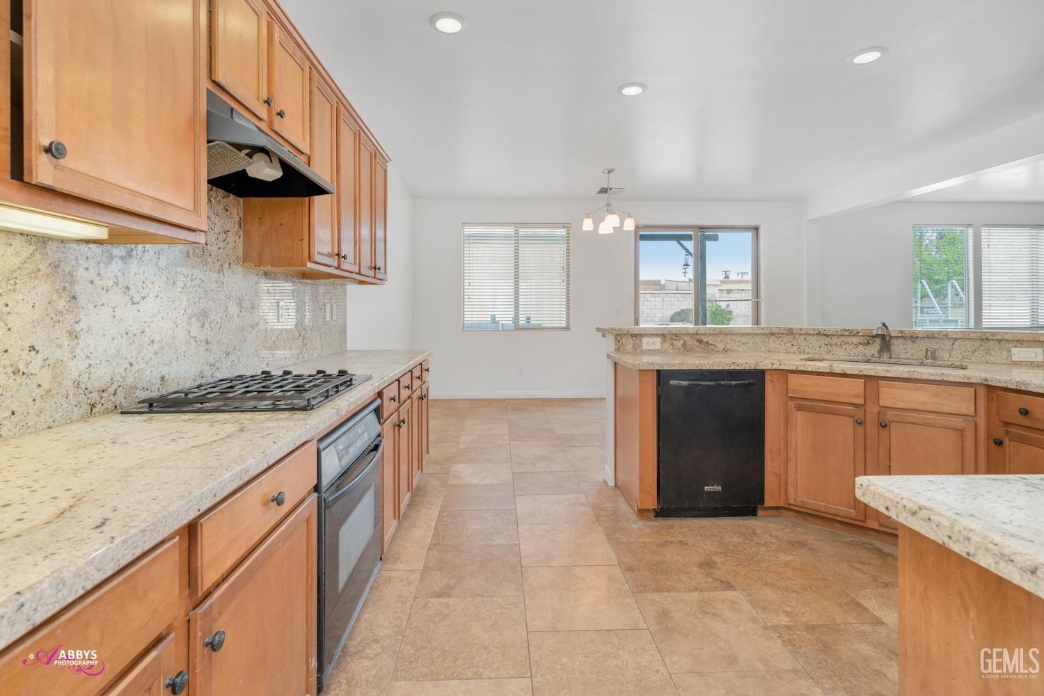 Undisclosed Address Bakersfield, CA 93312 - Photo 23 of 44 a kitchen with stainless steel appliances granite countertop a stove and a sink